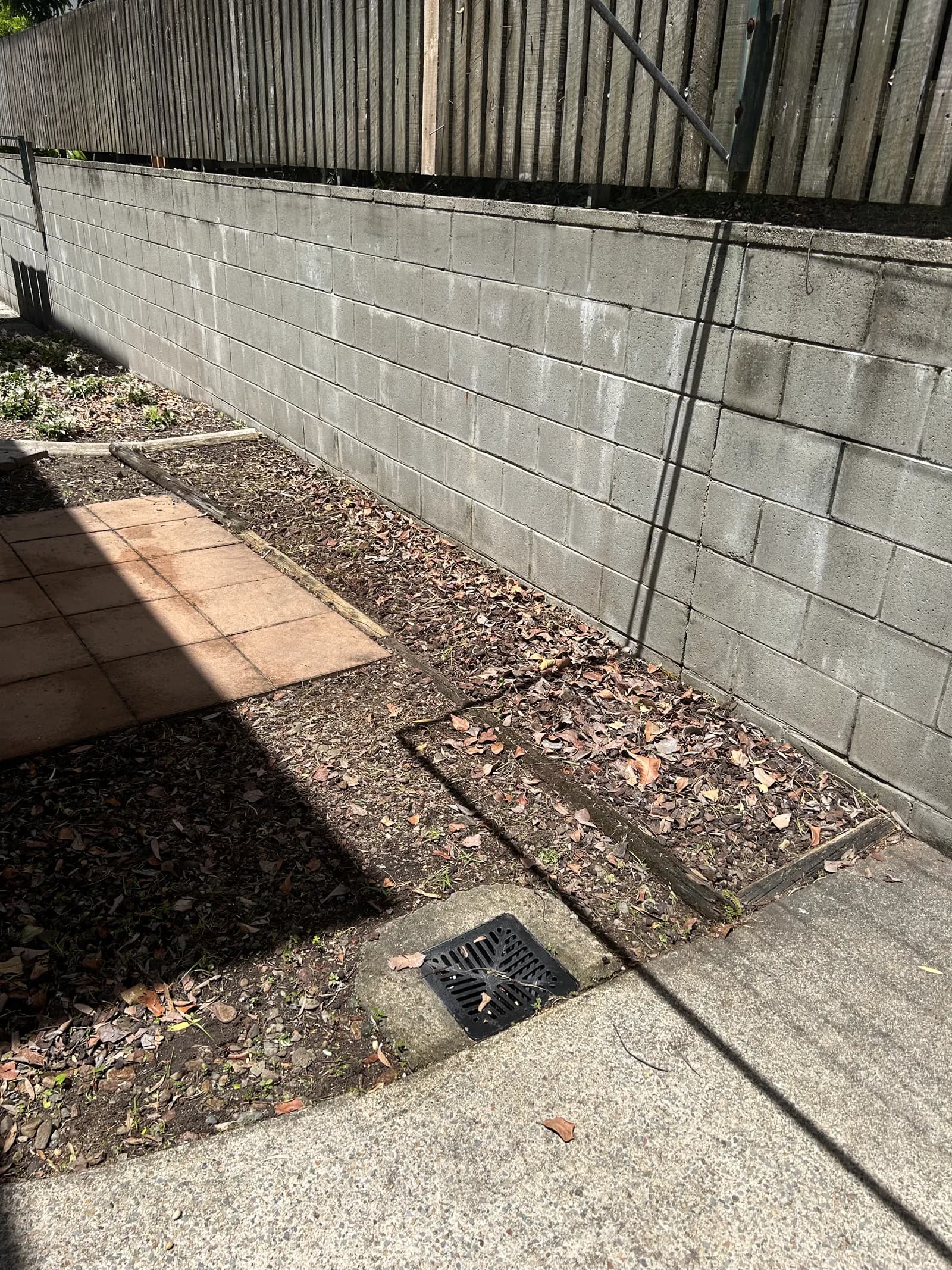 Same paved courtyard cleared and tidied with weeds removed from pavers after Lucky Duck Mowing
