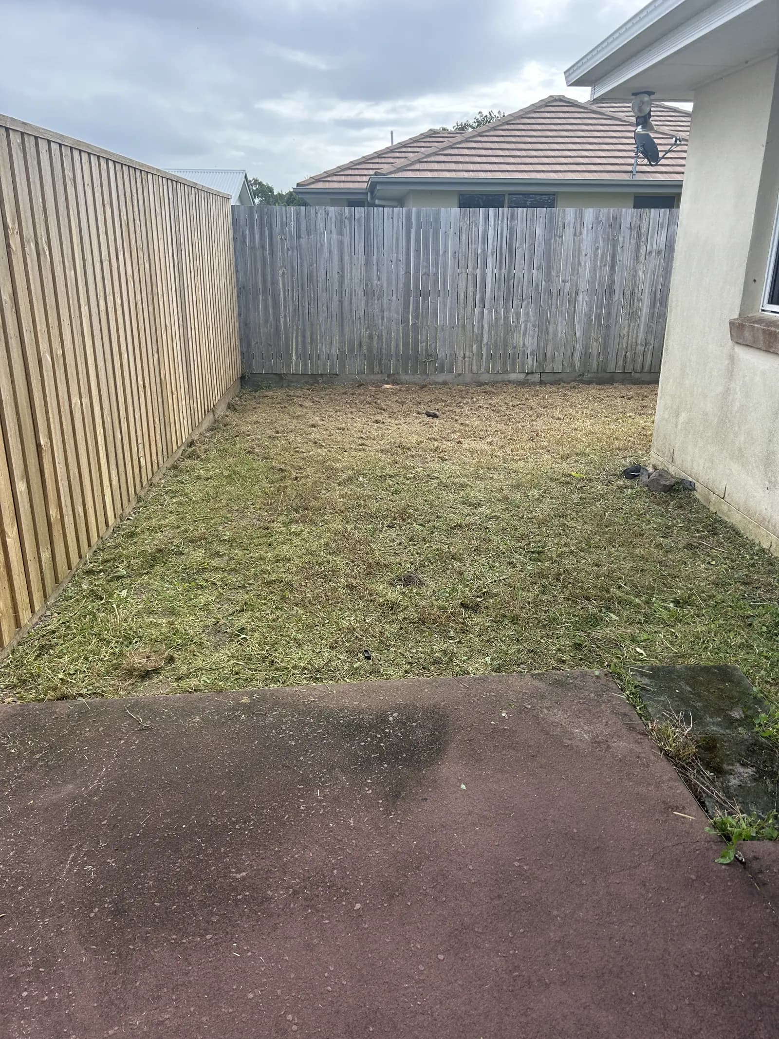 Same deck edge, line-trimmed back to dirt after Lucky Duck Mowing