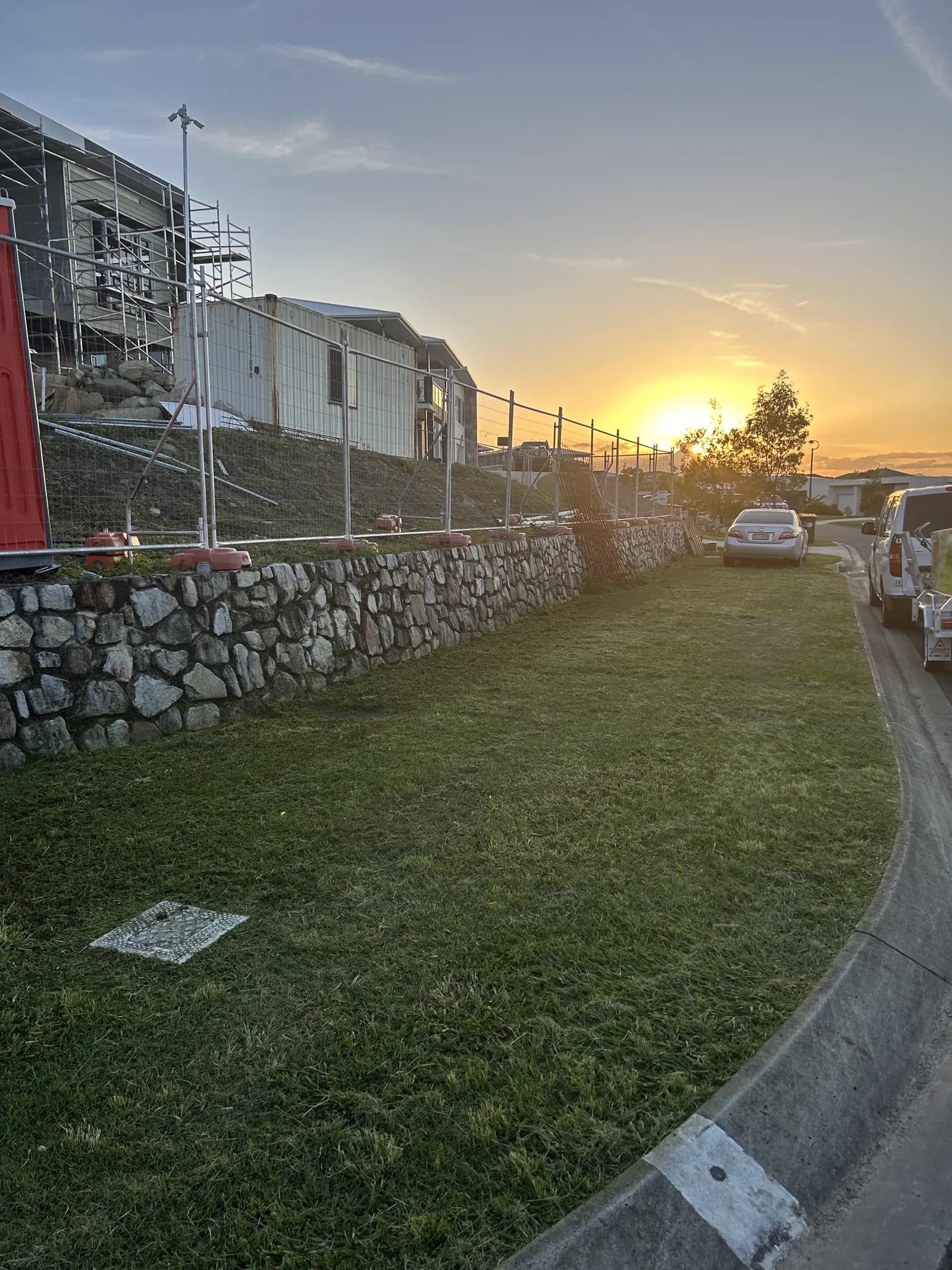 The same lawn neatly cut, golden hour finish, after Lucky Duck Mowing